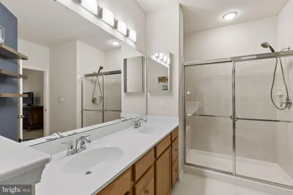 a bathroom with a sink and mirror with toilet