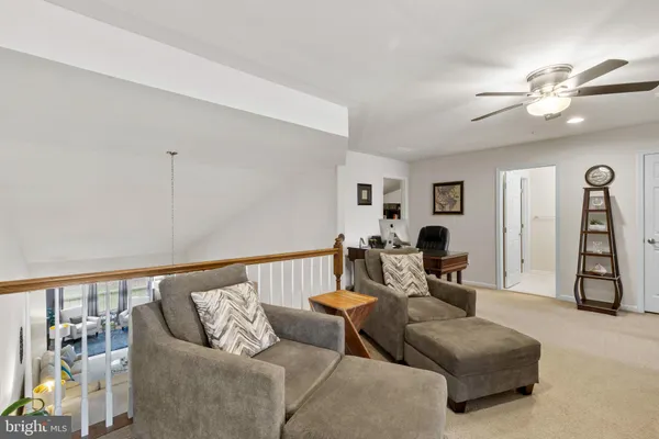 a bedroom with furniture and a flat screen tv