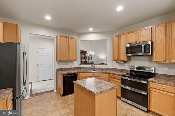 a kitchen with stainless steel appliances granite countertop refrigerator sink and cabinets
