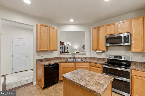 a kitchen with granite countertop a sink and appliances