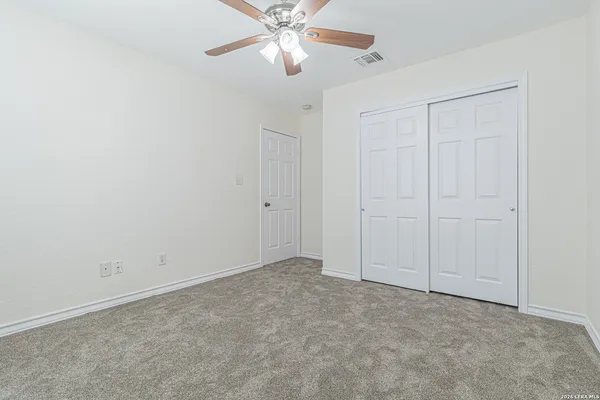 a view of a house with a yard and wooden fence