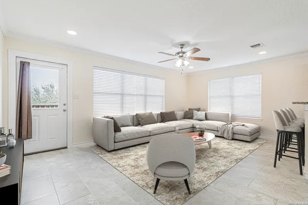 a living room with furniture a rug and a chandelier