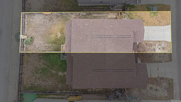 an aerial view of a house with table and chairs