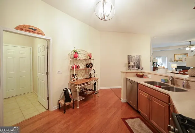 a kitchen with granite countertop a sink appliances and cabinets