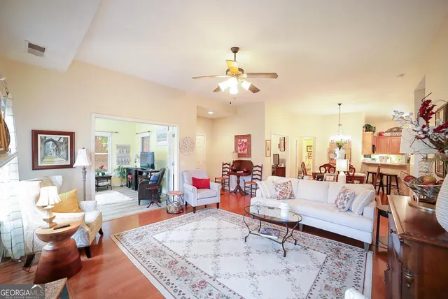 a living room with furniture and a chandelier