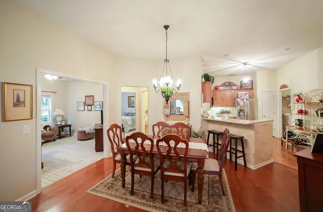 a kitchen with kitchen island granite countertop a sink appliances and cabinets