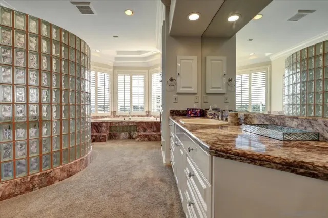 a bathroom with a sink a vanity and a large mirror