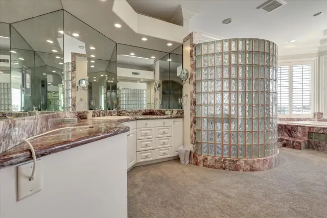 a bathroom with sinks and large windows