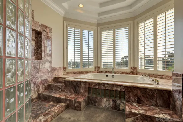 a large bathroom with a large mirror vanity and shower