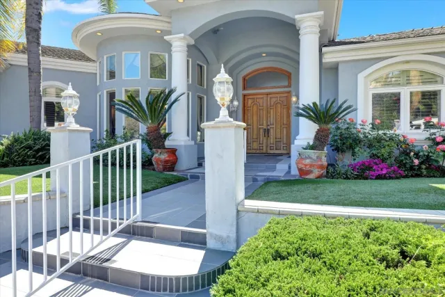 a front view of a house with a garden