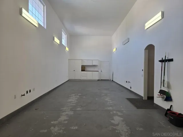 an empty room with a empty space and windows