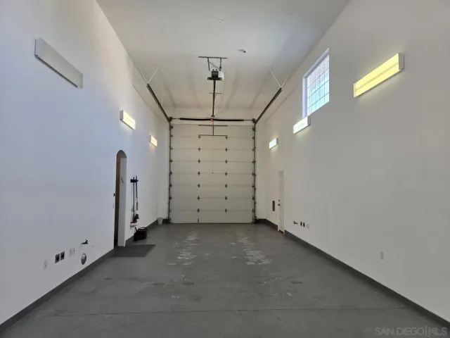 a view of a hallway with wooden shelves