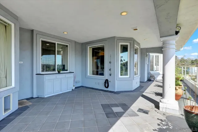 a view of a balcony with lake view and a potted plant