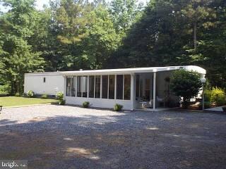 7107 Libertytown Road Berlin, MD 21811 - Photo 1 of 6 a view of a house with backyard and trees