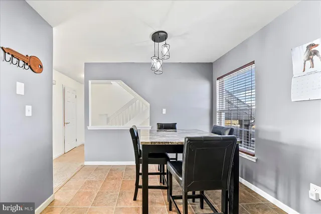a view of a dining room with furniture and window