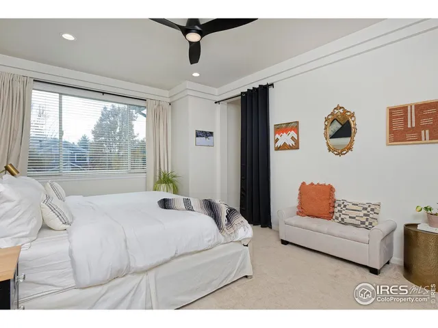 a bedroom with a bed and a painting