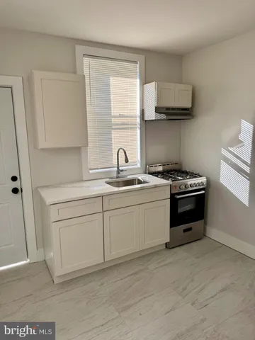 a kitchen with a stove and a sink