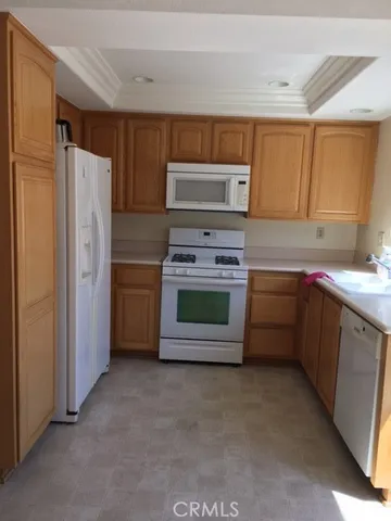 a kitchen with stainless steel appliances a stove sink and refrigerator