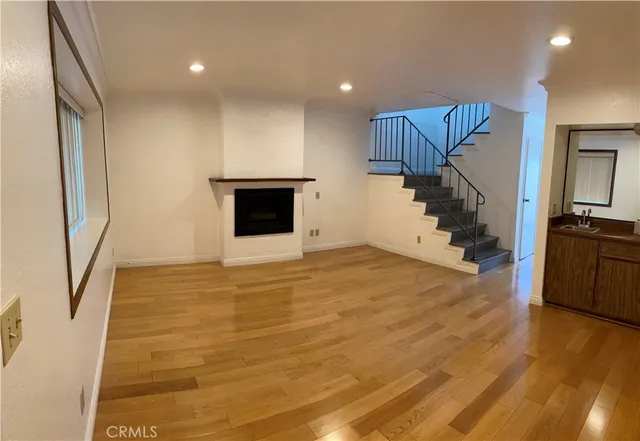 a view of a kitchen with a sink and a refrigerator