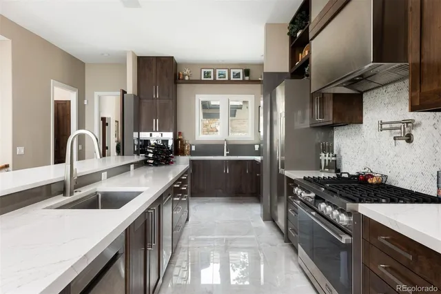 a kitchen with a sink stove top oven and cabinets