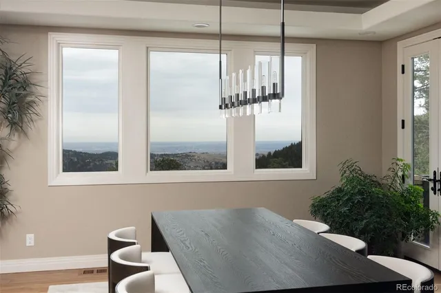 a view of a room that has a window and wooden floor