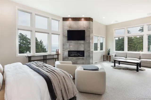 a large white kitchen with a large window and stainless steel appliances
