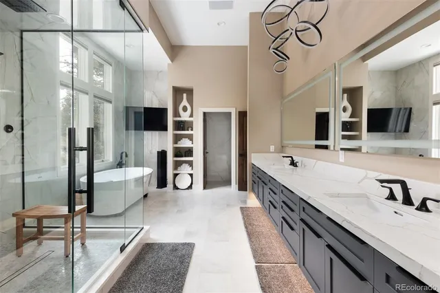 a spacious bathroom with a double vanity sink toilet mirror and shower
