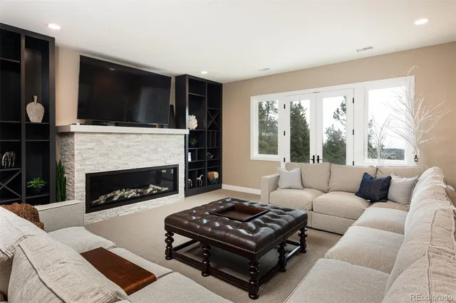 a living room with furniture and a fireplace