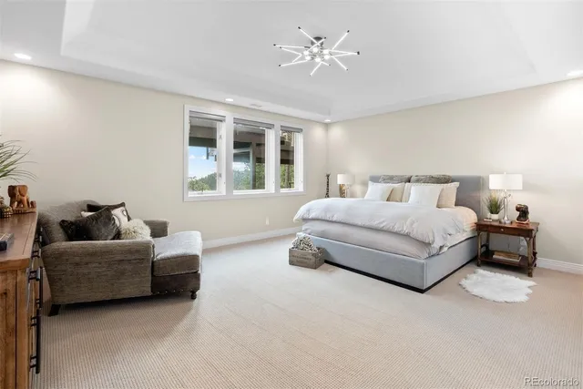 a view of a hallway with furniture and wooden floor
