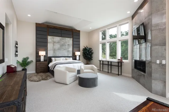 a living room with furniture and large windows