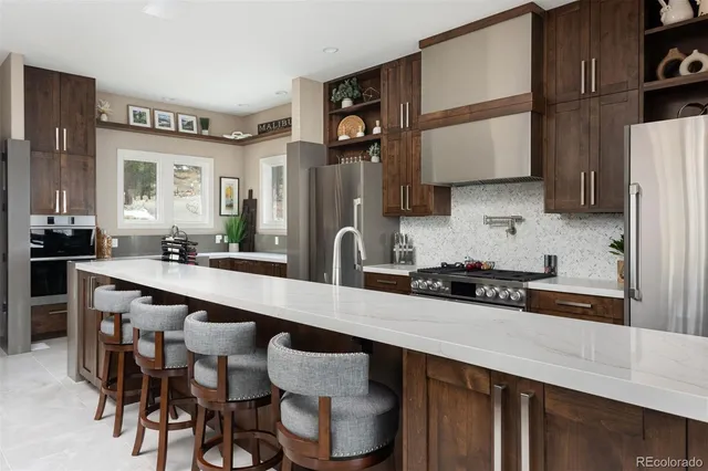 a kitchen with a table chairs sink and cabinets