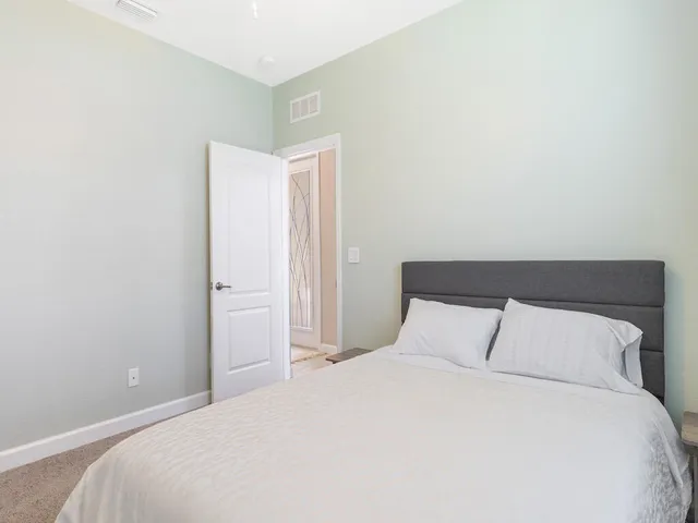 a bedroom with a bed and a night stand