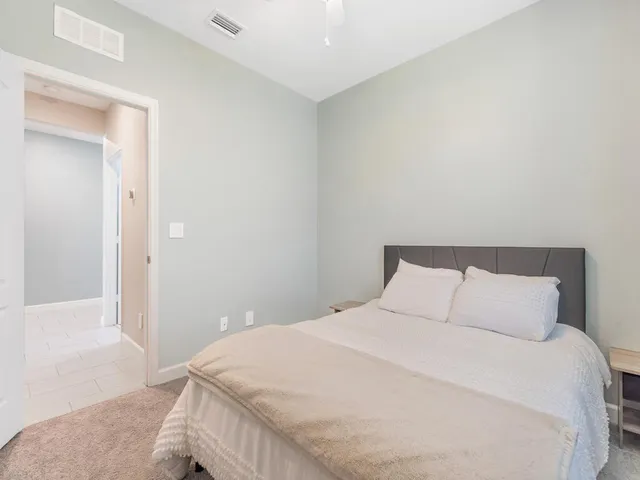 a bedroom with a bed and a mirror