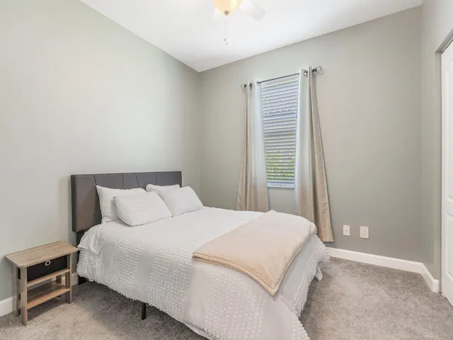 a bedroom with a bed and a window