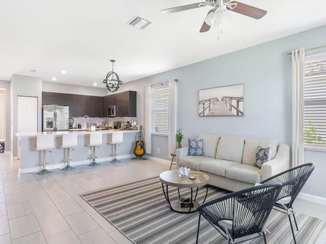 a living room with furniture and kitchen view