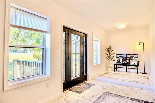 a bedroom with furniture and a window
