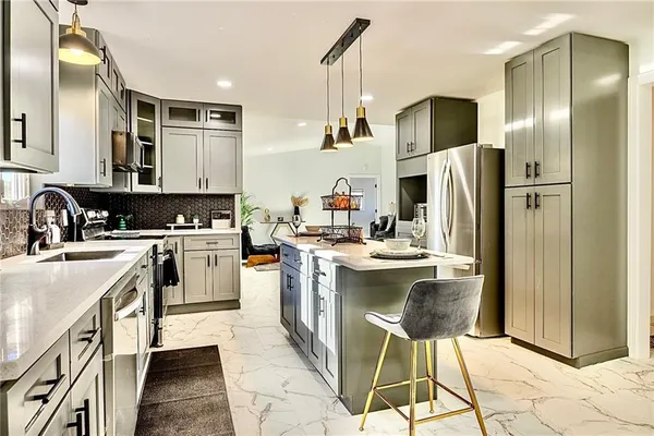 a kitchen with a sink appliances and cabinets
