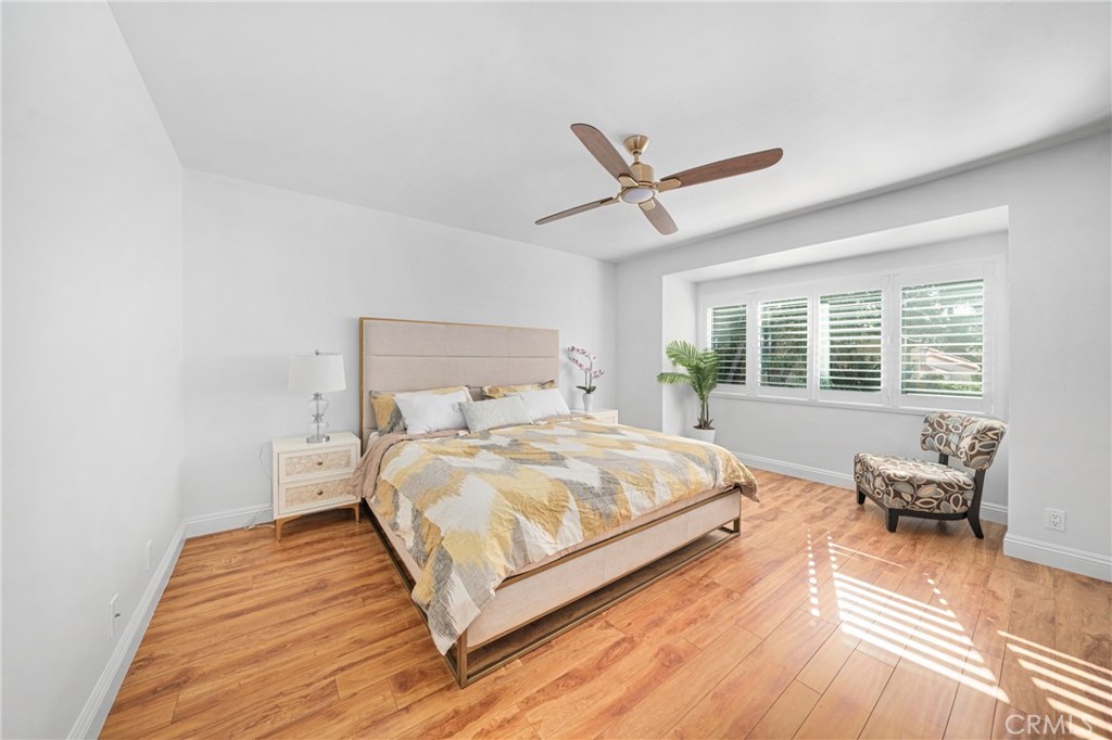 60 Willow Tree Lane Irvine, CA 92612 - Photo 12 of 32 a bedroom with a bed and wooden floor