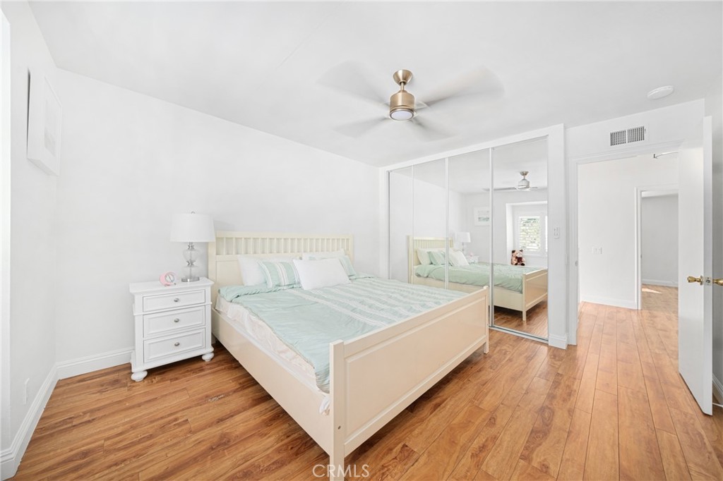 60 Willow Tree Lane Irvine, CA 92612 - Photo 16 of 32 a bedroom with a large bed and a chandelier