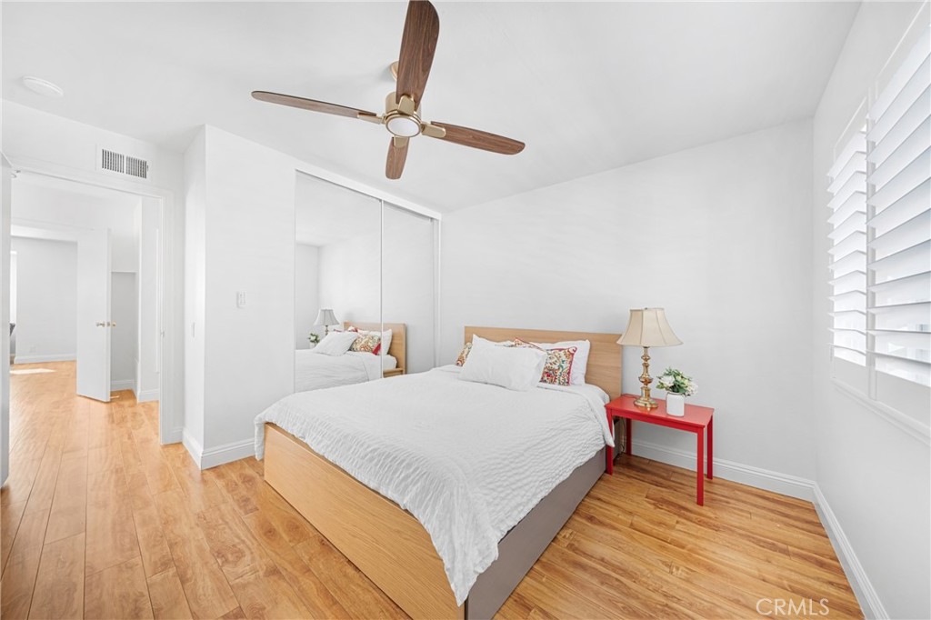 60 Willow Tree Lane Irvine, CA 92612 - Photo 19 of 32 a bedroom with a bed and wooden floor