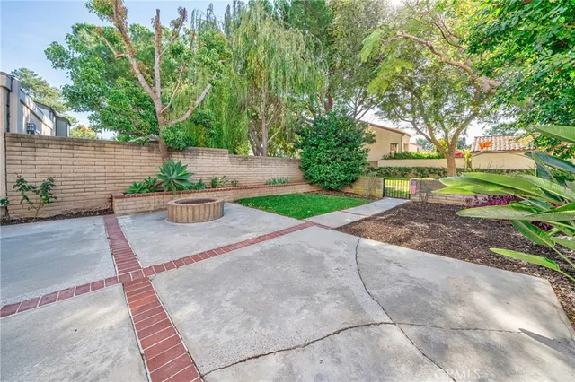 a view of backyard with plants and trees
