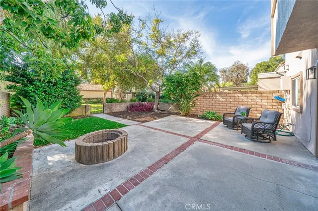a view of a patio with table and chairs and potted plants
