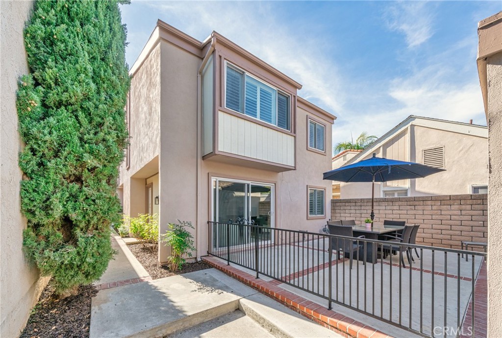 60 Willow Tree Lane Irvine, CA 92612 - Photo 25 of 32 a view of a patio with a table and chairs