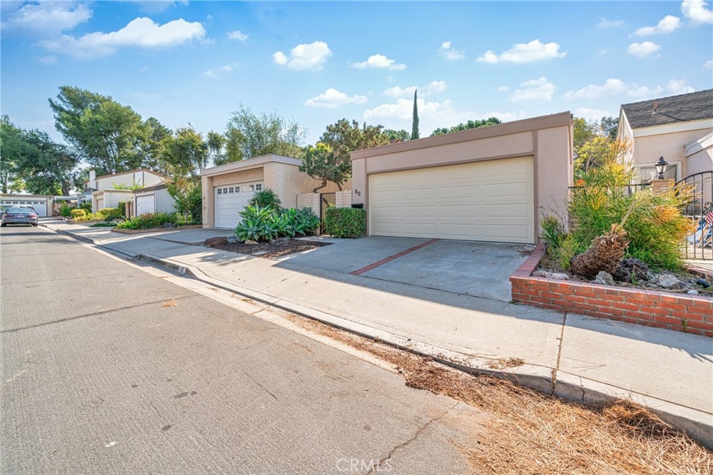 60 Willow Tree Lane Irvine, CA 92612 - Photo 27 of 32 a front view of a house with a yard and a garage