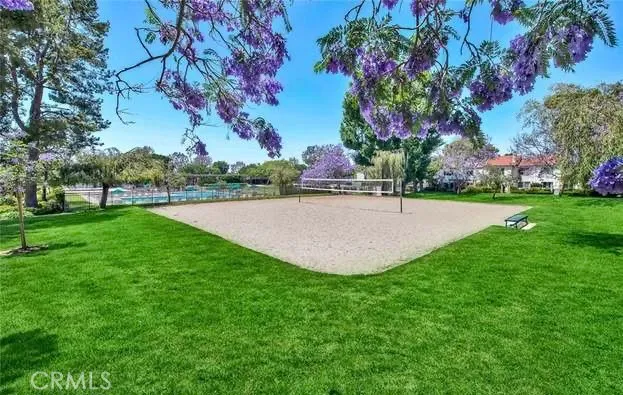 a front view of a house with a yard and potted plants