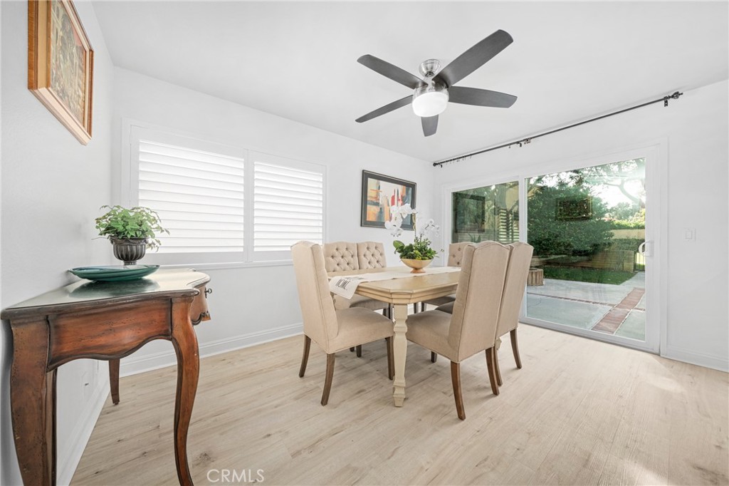 60 Willow Tree Lane Irvine, CA 92612 - Photo 4 of 32 a dining room with furniture a potted plant and a large window