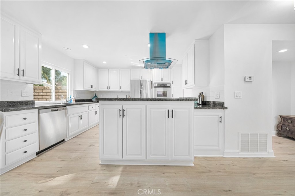 60 Willow Tree Lane Irvine, CA 92612 - Photo 8 of 32 a kitchen with white cabinets