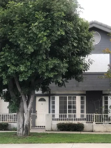 a front view of a house with a garden and plants