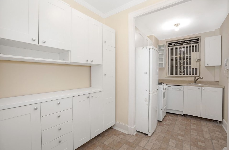 135 West 58th Street, Unit 1C Manhattan, NY 10019 - Photo 6 of 9 a view of cabinets and window