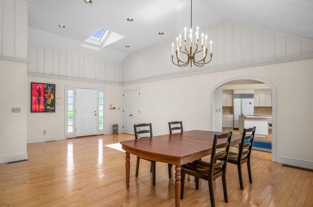 a view of a dining room with furniture wooden floor and chandelier